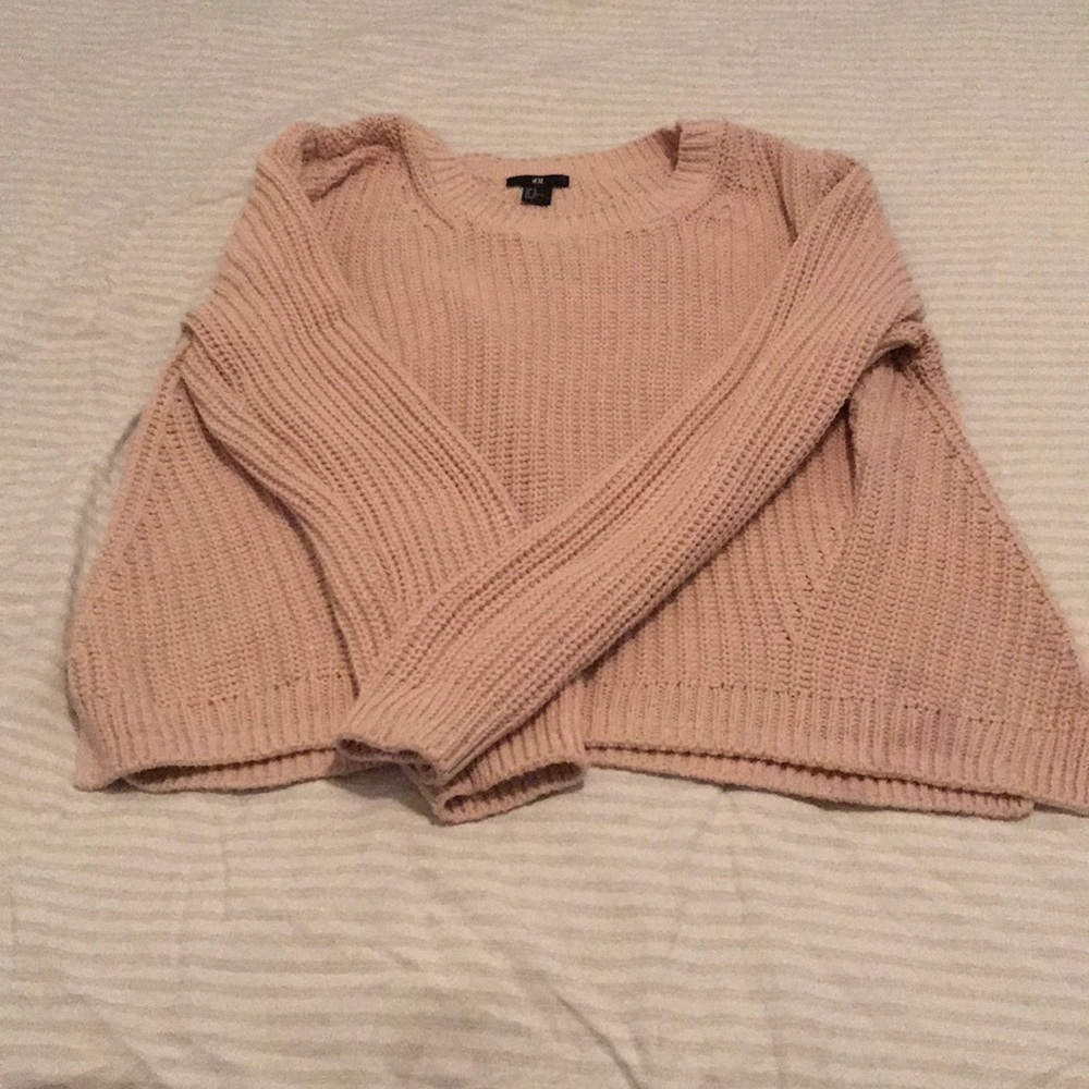 A pale pink sweater.